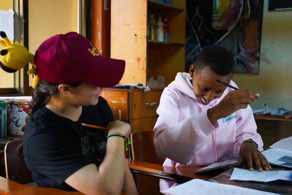 A volunteer works with a student at the Agahozo-Shalom Youth Village in Rwanda.