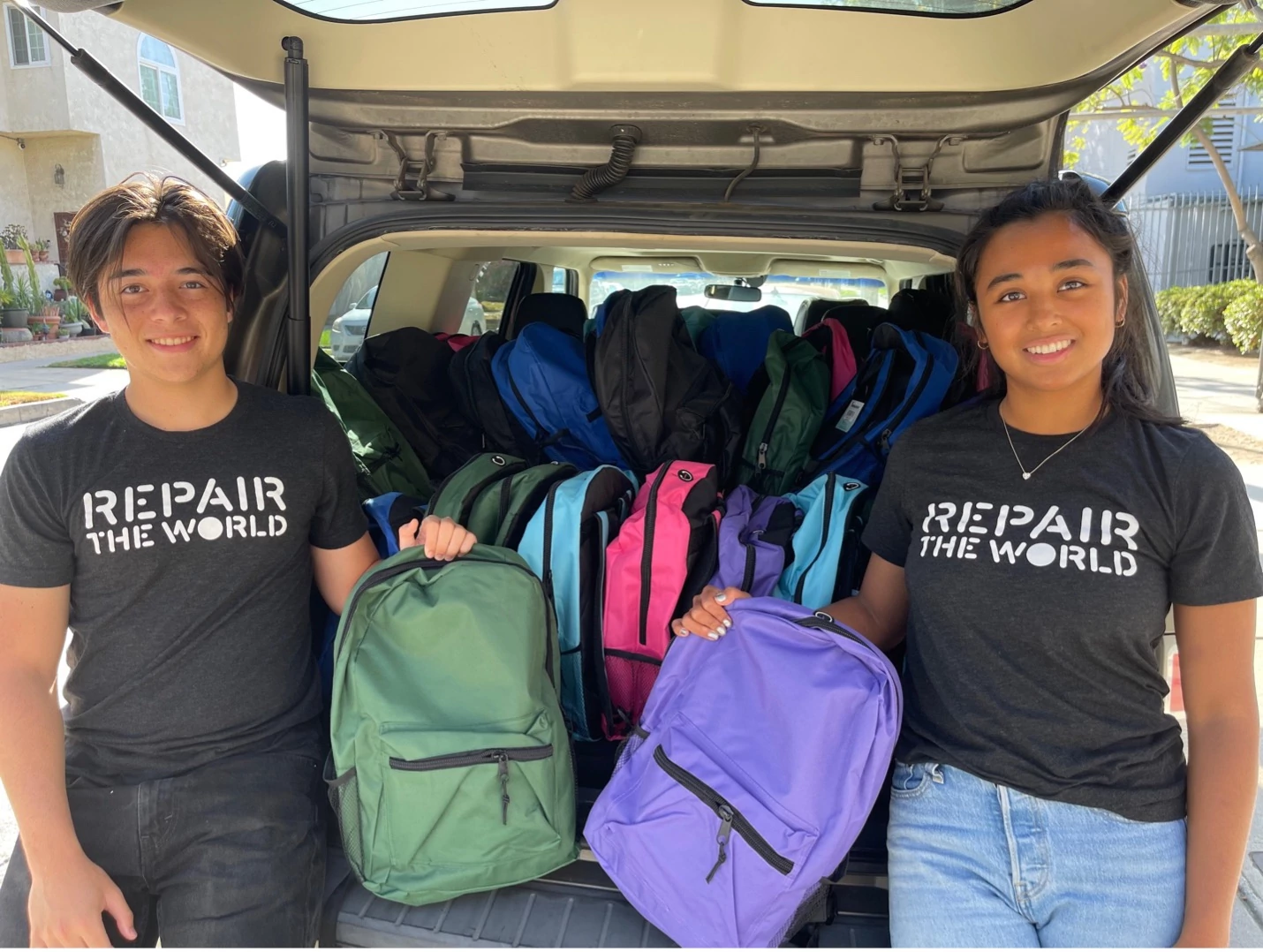 Two members of the Repair the World Service Corps deliver backpacks to an elementary school in Los Angeles as a part of Repair the World’s backpack campaign.