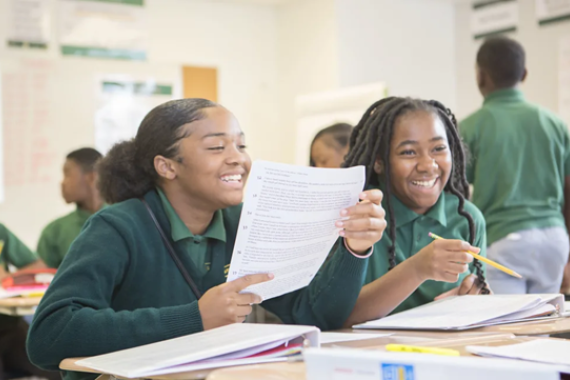 Two students smiling in the classroom.