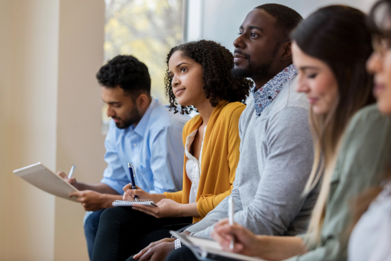 Adult learners listen attentively in class