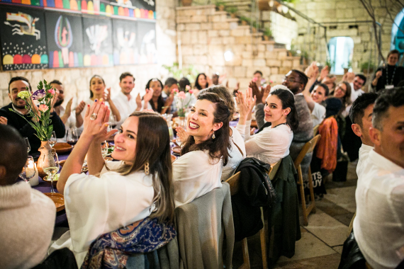 Group of people sitting at a table applauding