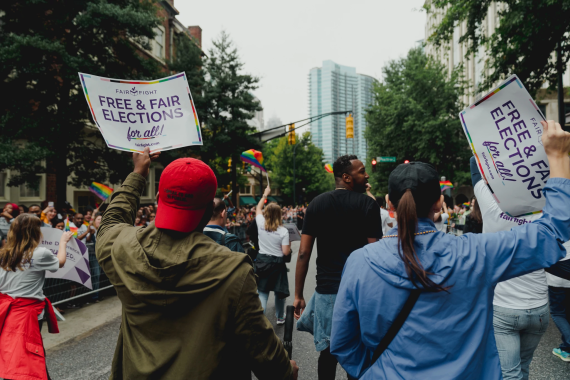 People holding Free and Fair Election signs