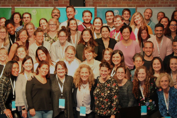 Schusterman staff smiling group photo