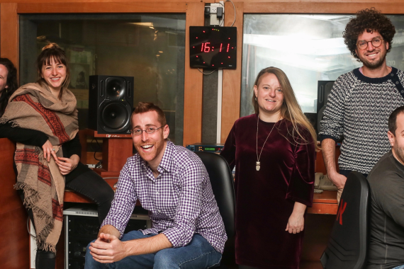 Seven members of the Israel Story podcast staff in the recording studio