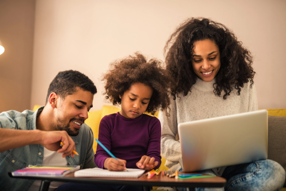 Parents helping daughter with homework