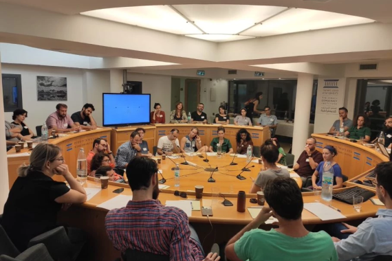 A group of people at table discussing policy