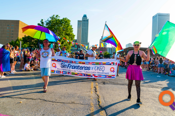 Advancing Equal Rights, two people draped in a rainbow flag