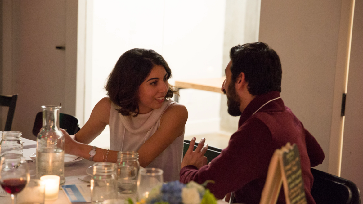 Two people talking at dining table