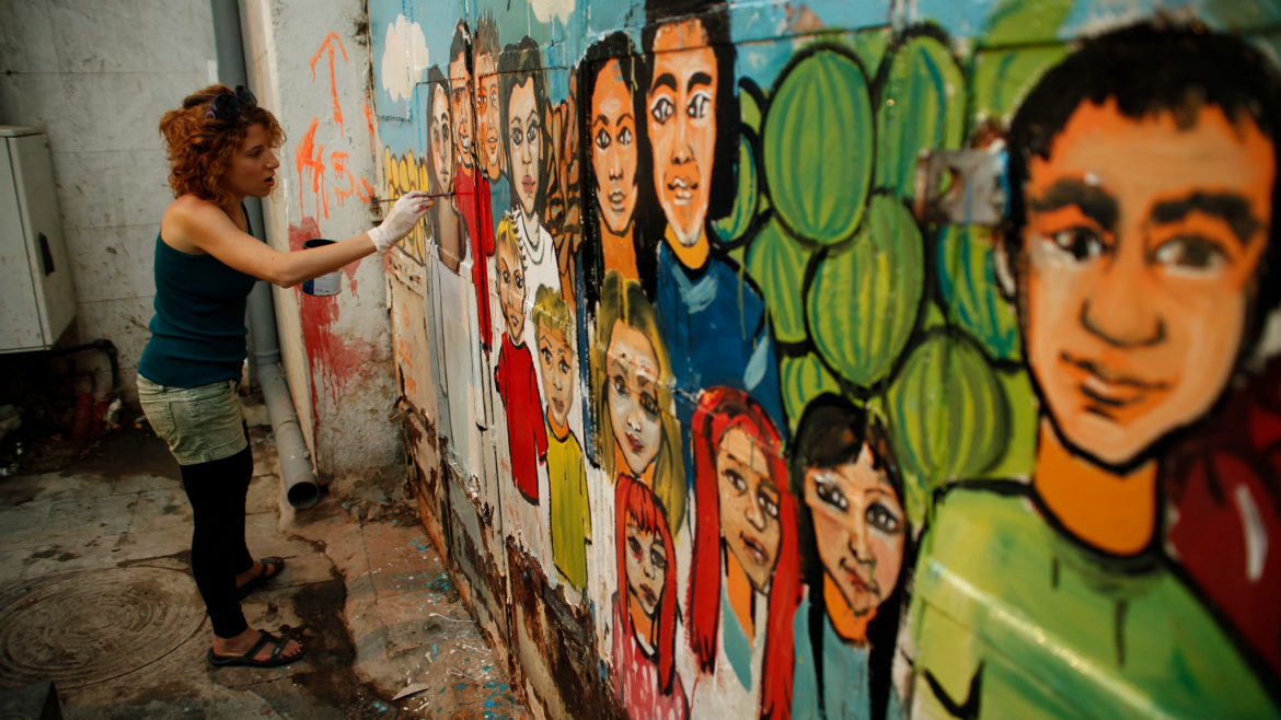 Woman painting a mural