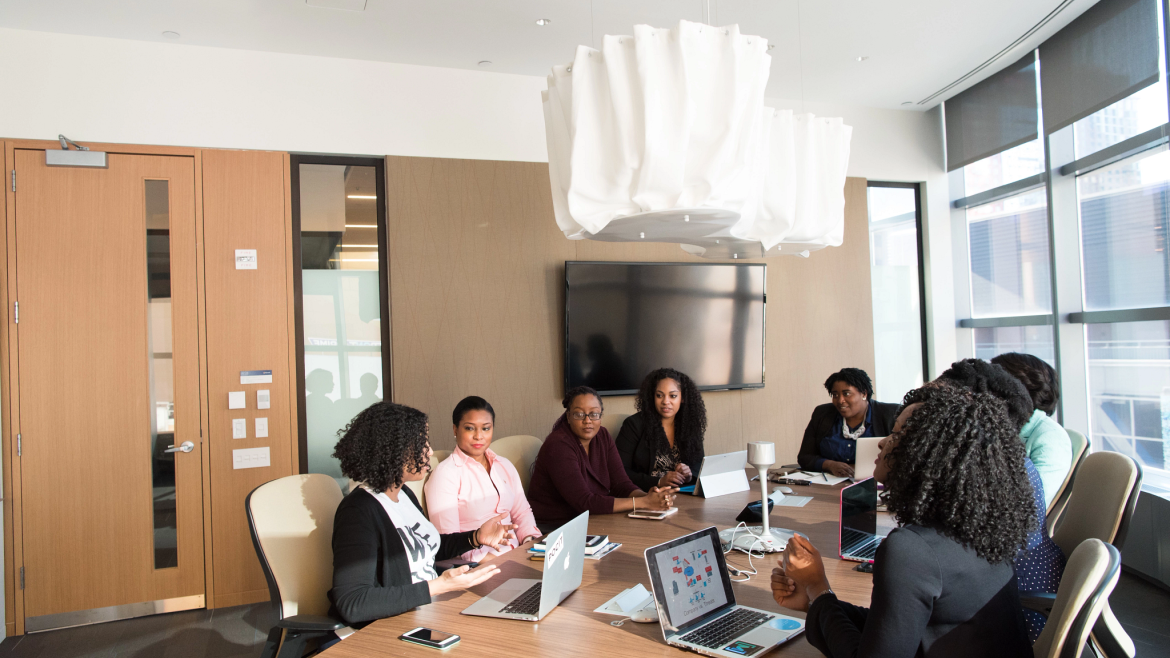 Group of Black women at a conference table