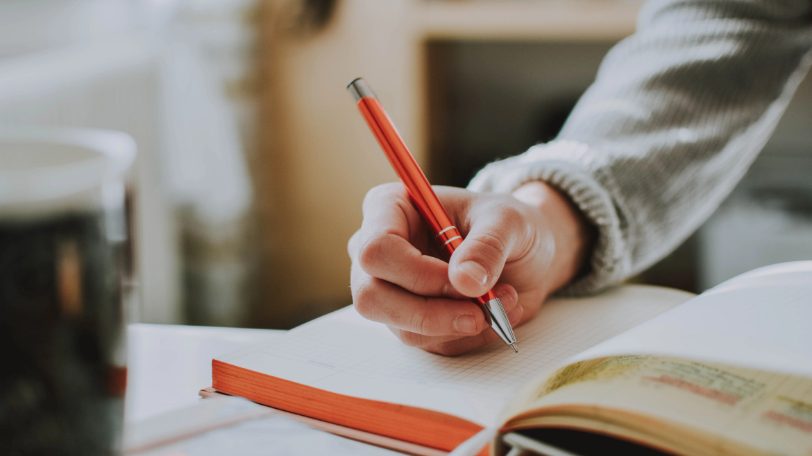 Person writing in a notebook