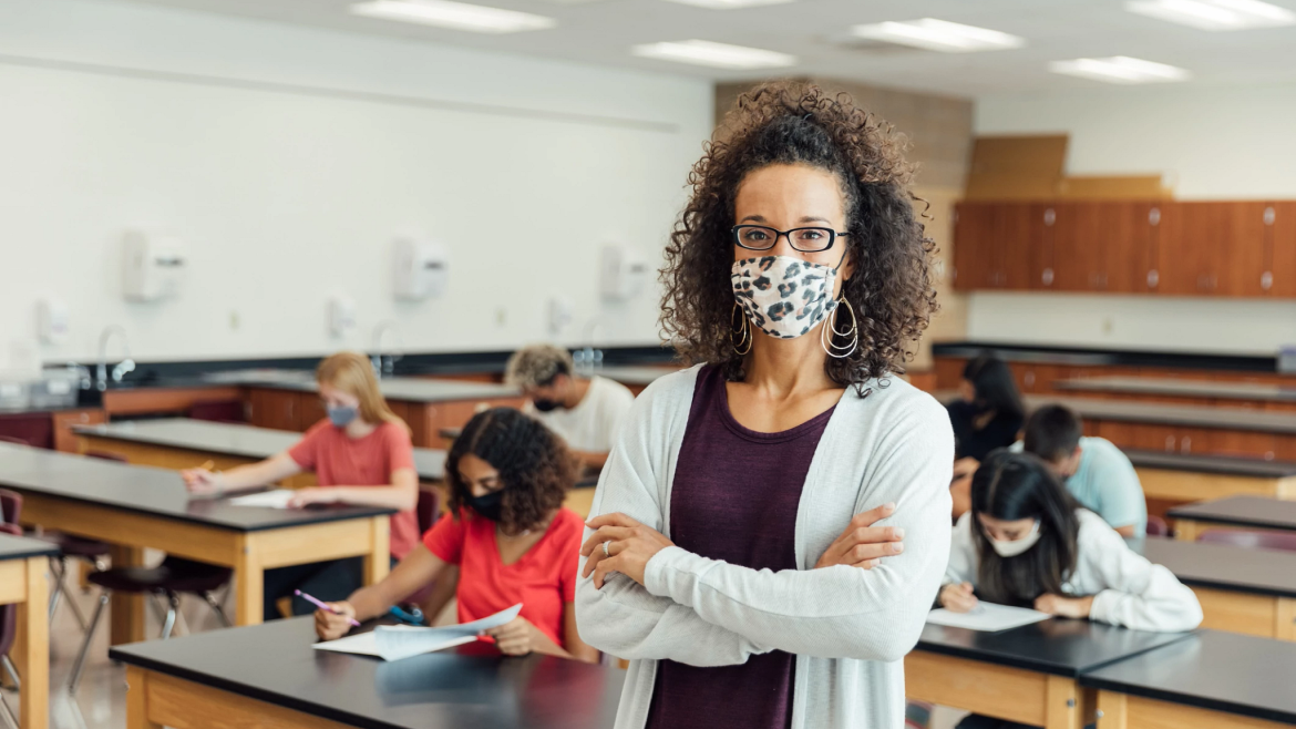 Masked instructor in front of masked students