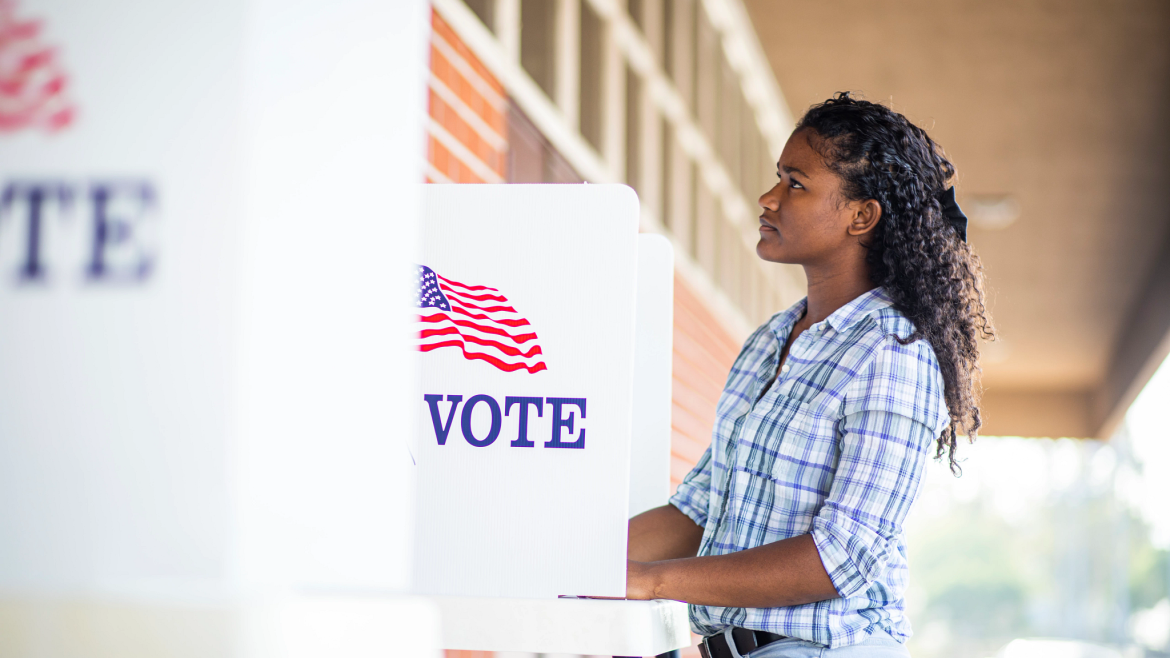 Woman using a voting booth