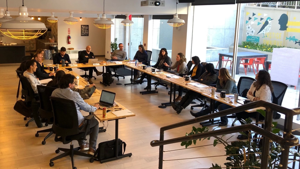 About 20 people in a modern conference room