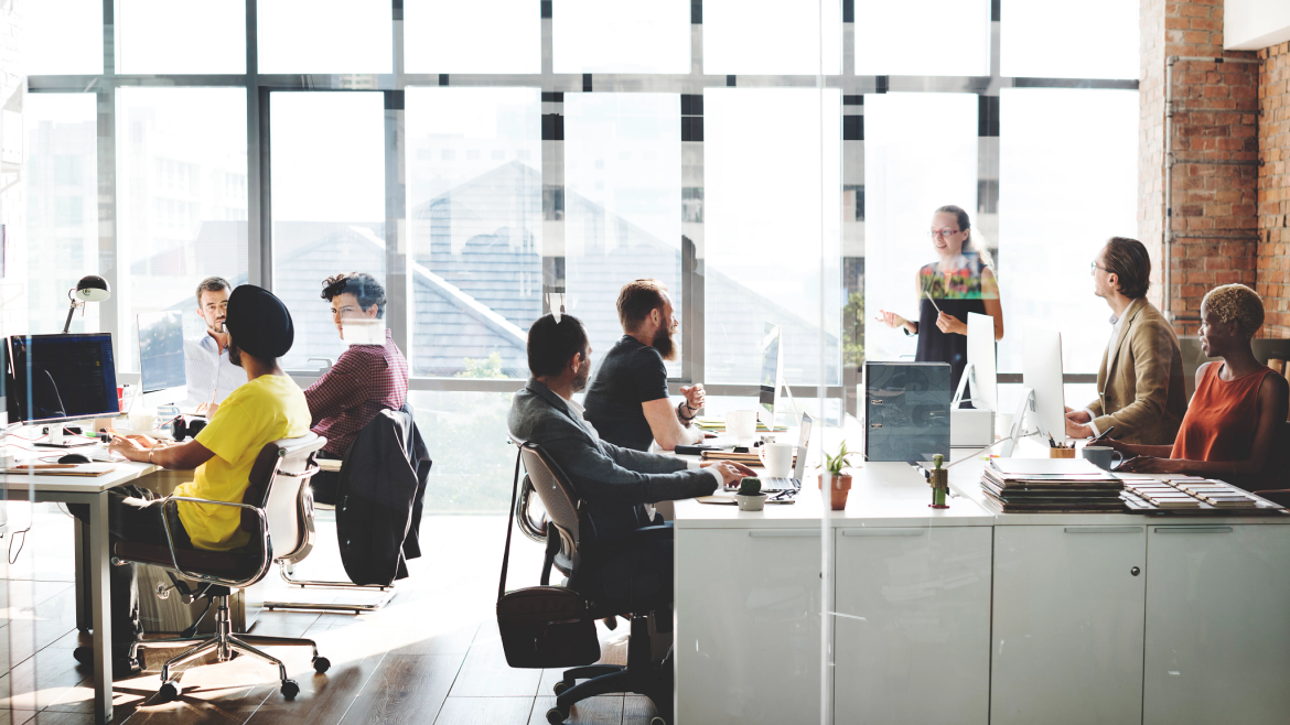 Coworkers side by side in a spacious open office