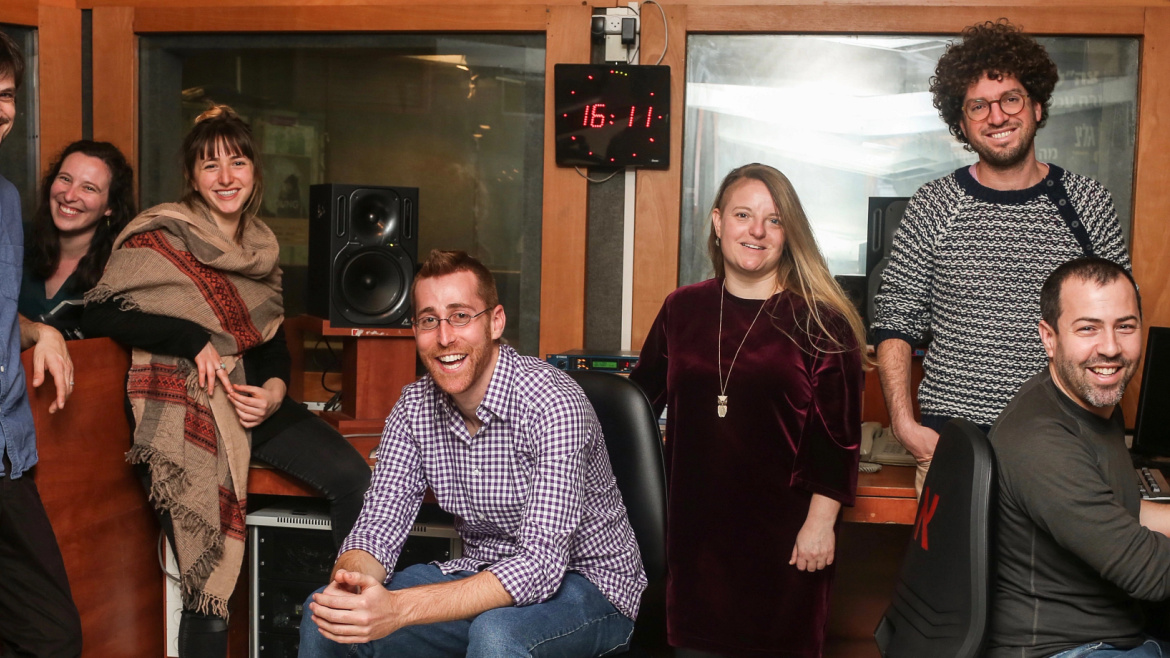 Seven members of the Israel Story podcast staff in the recording studio