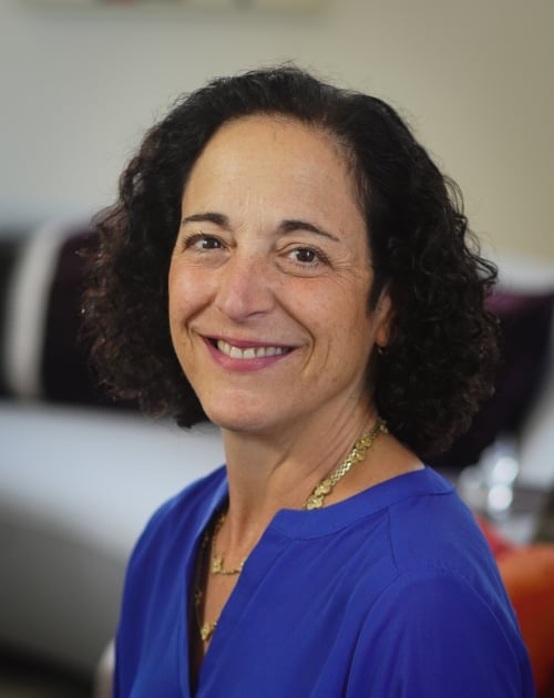 Image of Stacy Schusterman Chair of Charles and Lynn Schusterman Family Philanthropies smiling at the camera wearing a blue top.