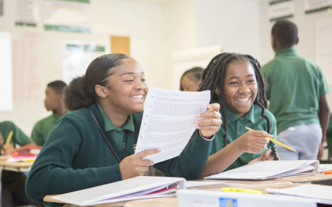 Two students smiling in the classroom.