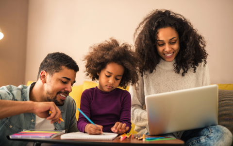 Parents helping daughter with homework
